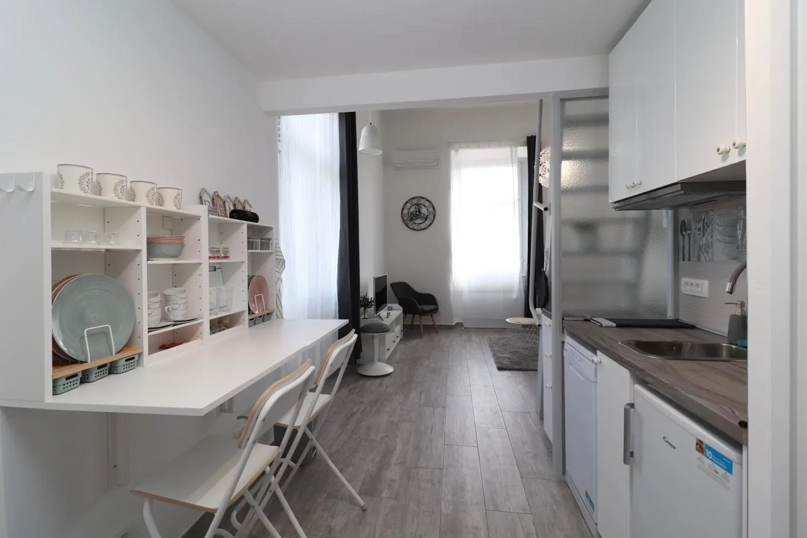 View along the kitchen and dining counter toward the window and living room.